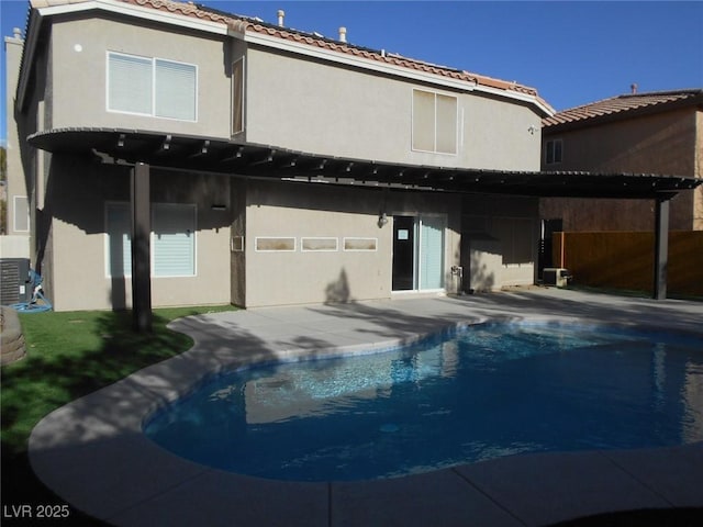 rear view of property with central AC unit and a patio area