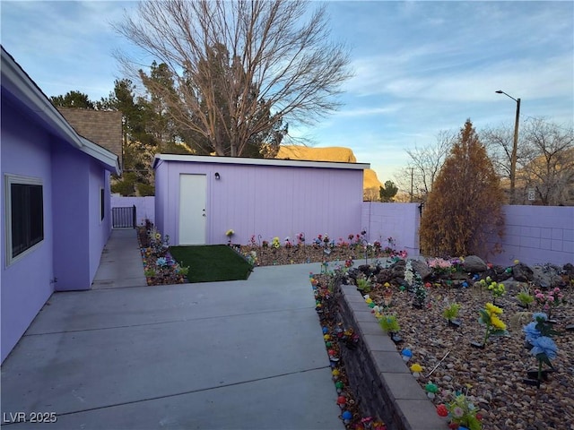 view of yard with an outbuilding and a patio