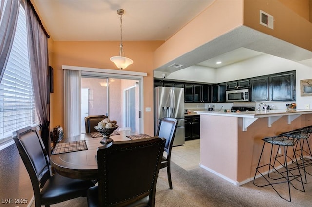 dining area featuring light colored carpet, visible vents, and recessed lighting