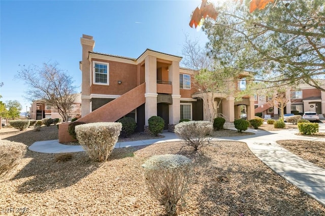 view of front of home featuring a chimney and stucco siding