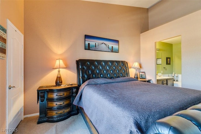 bedroom featuring carpet, baseboards, and ensuite bathroom