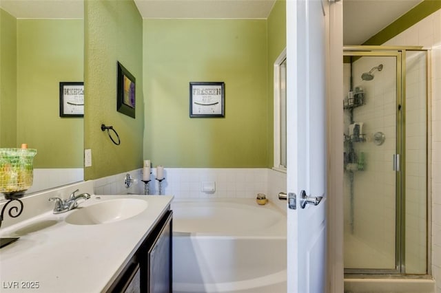 full bathroom featuring a shower stall, vanity, and a bath