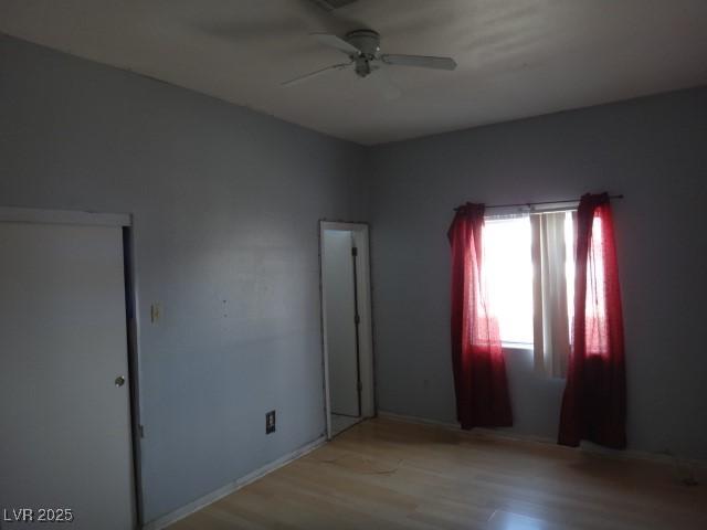 empty room featuring ceiling fan and light wood-style floors