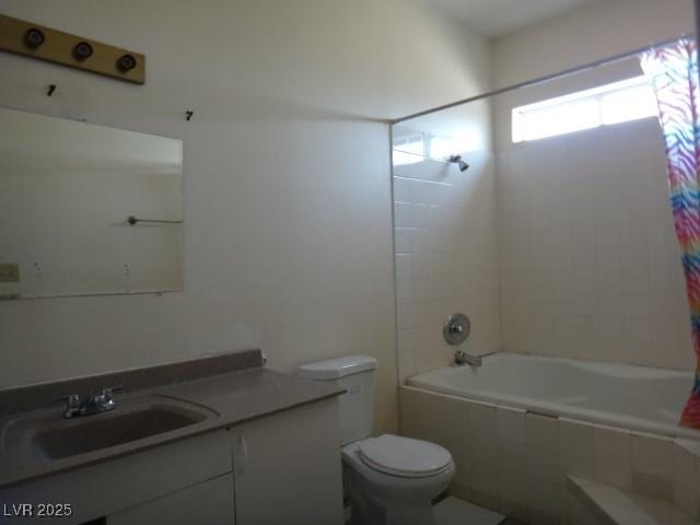 full bath featuring tiled shower / bath combo, vanity, and toilet