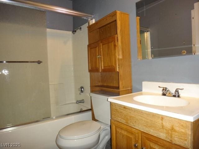 full bath with toilet, bath / shower combo with glass door, and vanity