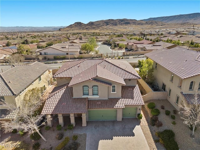 birds eye view of property with a mountain view and a residential view