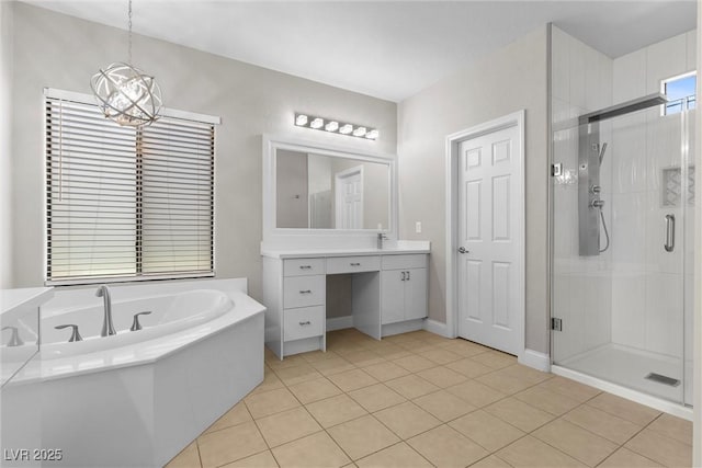 bathroom featuring a notable chandelier, vanity, a shower stall, a bath, and tile patterned floors