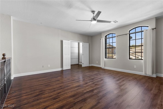 unfurnished bedroom with ceiling fan, wood finished floors, visible vents, and baseboards