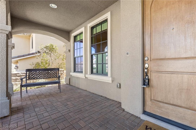 property entrance featuring stucco siding