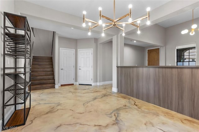 unfurnished room featuring concrete floors, baseboards, and stairs