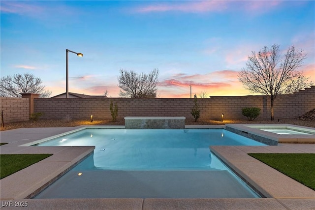 pool at dusk with an in ground hot tub, a fenced backyard, and a fenced in pool