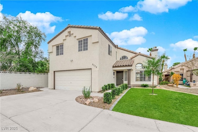 mediterranean / spanish home with a front lawn and a garage