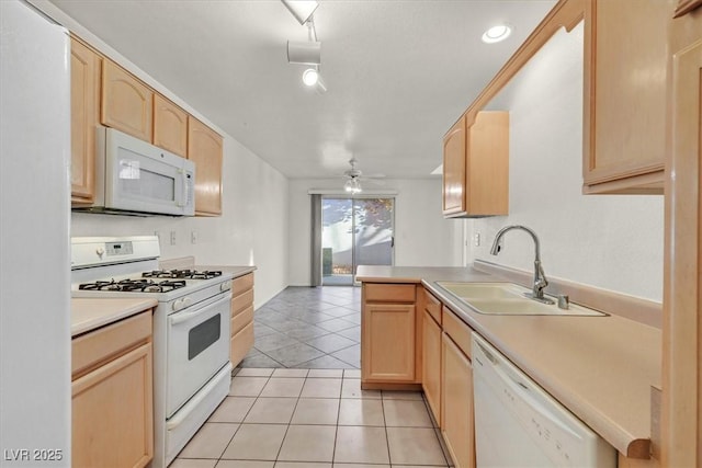 kitchen with sink, white appliances, ceiling fan, light tile patterned floors, and light brown cabinetry