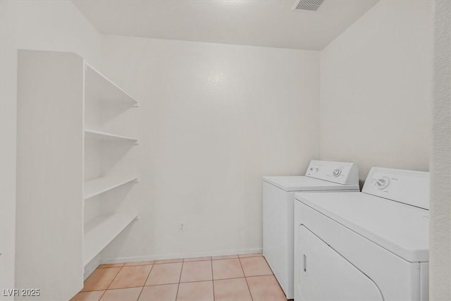 washroom featuring light tile patterned floors and washer and dryer