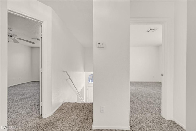 hallway with light colored carpet