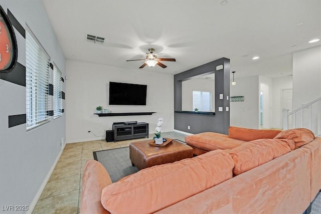 living room with light tile patterned floors, baseboards, visible vents, a ceiling fan, and recessed lighting