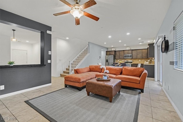 living area with recessed lighting, light tile patterned flooring, stairway, and baseboards