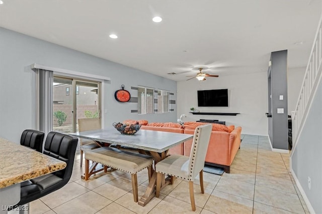 dining space with light tile patterned floors, ceiling fan, recessed lighting, baseboards, and stairway