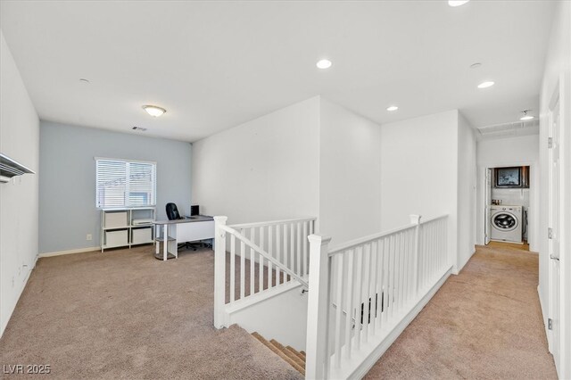 corridor with recessed lighting, carpet floors, visible vents, an upstairs landing, and washer / dryer