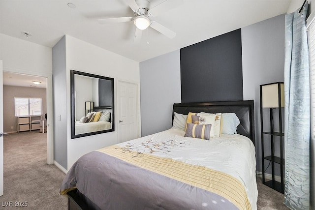 carpeted bedroom with a ceiling fan and baseboards