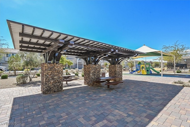 view of property's community with playground community and a pergola