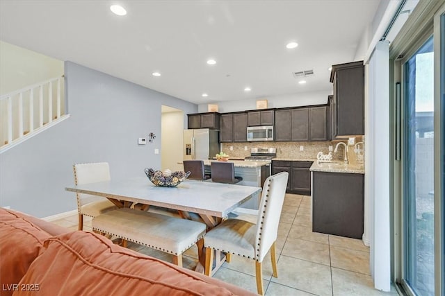 dining room featuring light tile patterned floors, baseboards, visible vents, and recessed lighting