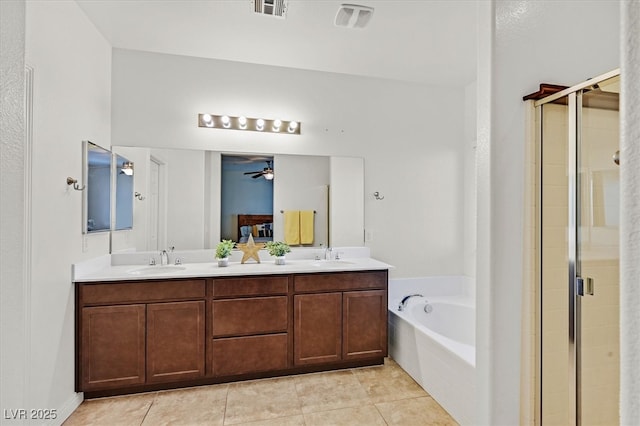 ensuite bathroom with a garden tub, a sink, and a shower stall