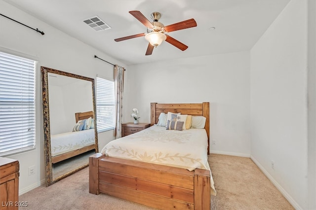 bedroom with light carpet, baseboards, visible vents, and ceiling fan