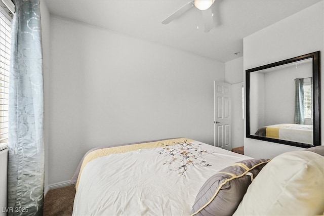 bedroom with carpet, baseboards, and a ceiling fan