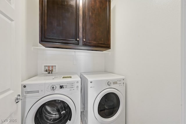 laundry area featuring cabinet space and washing machine and clothes dryer