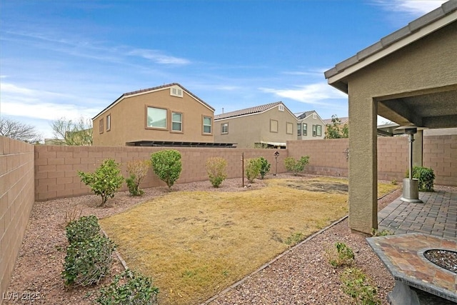 view of yard featuring a patio and a fenced backyard