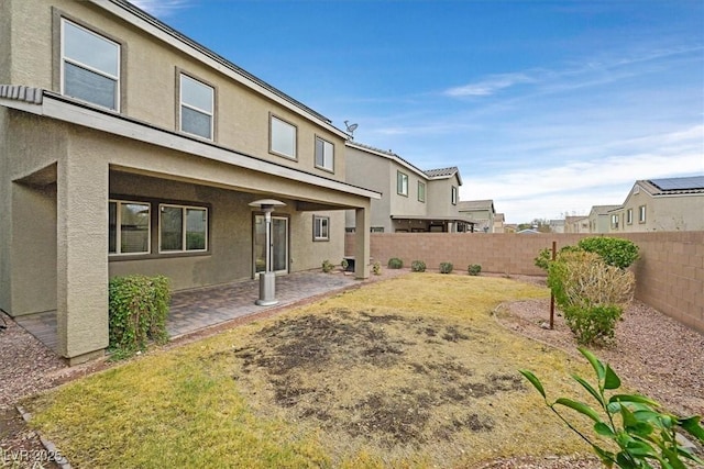 back of house featuring a patio area, a fenced backyard, and stucco siding