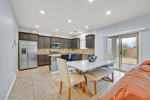 dining area with light tile patterned floors, a wealth of natural light, and recessed lighting