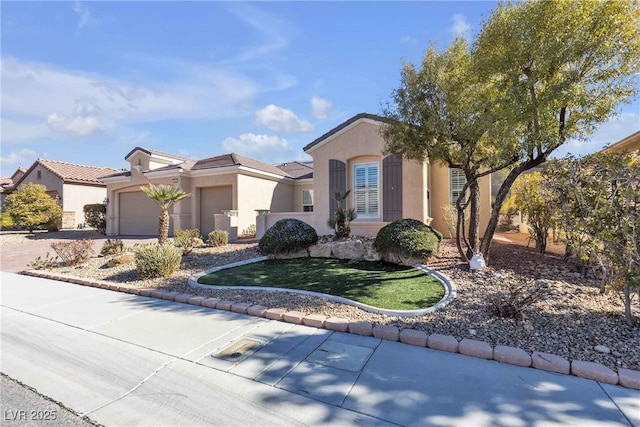 mediterranean / spanish-style home featuring an attached garage, driveway, a tile roof, and stucco siding