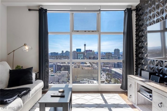 living area with a view of city and wood finished floors