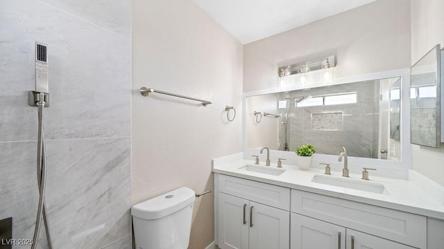 bathroom with an enclosed shower, vanity, and toilet