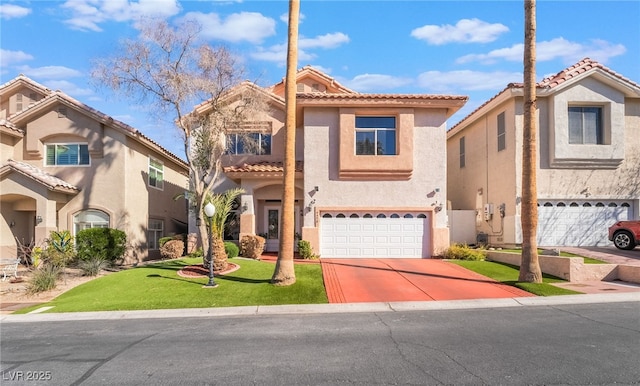 mediterranean / spanish home with concrete driveway, a tiled roof, an attached garage, a front lawn, and stucco siding