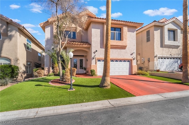 mediterranean / spanish house with driveway, stucco siding, a tiled roof, an attached garage, and a front yard