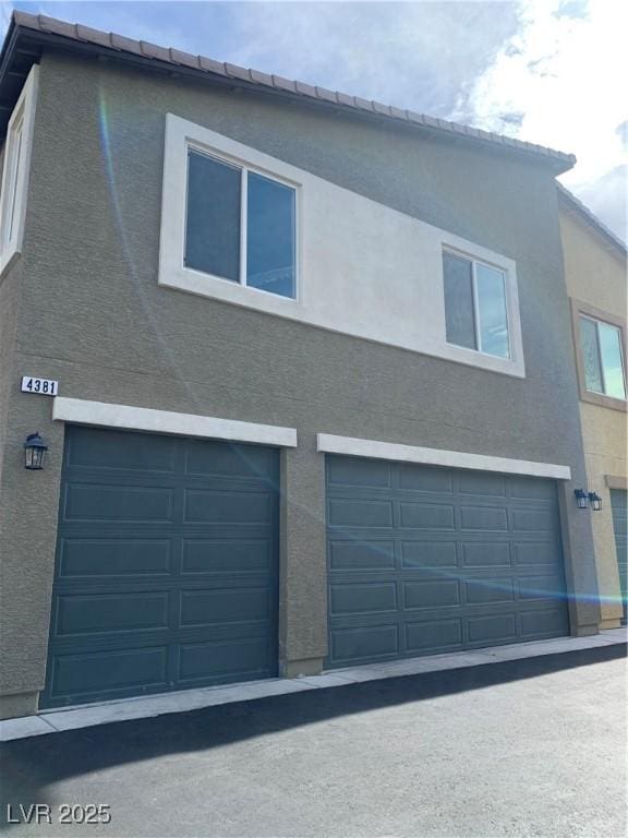 view of property exterior featuring a garage and stucco siding