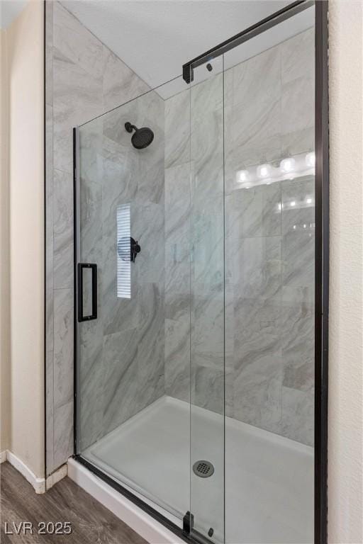 bathroom featuring wood-type flooring and walk in shower