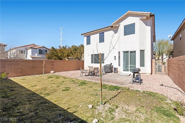 back of property with a patio and a yard