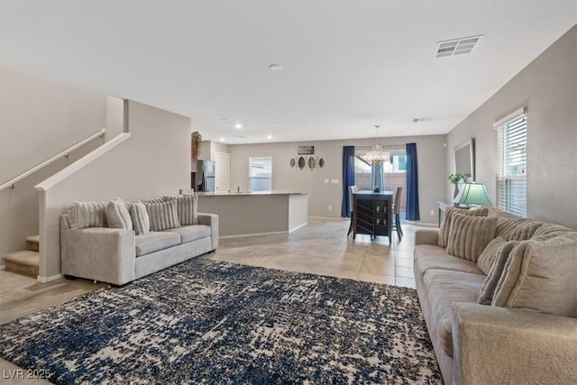 living room featuring light tile patterned floors and a notable chandelier