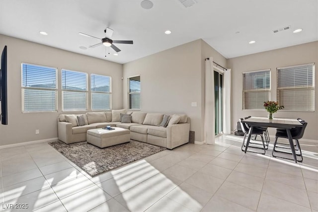 tiled living room with ceiling fan