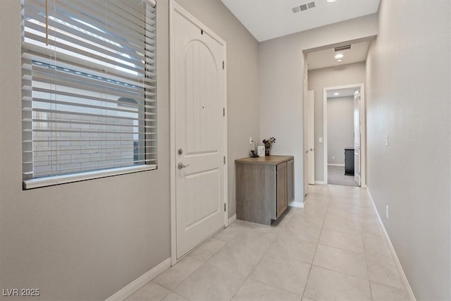 hall with light tile patterned floors