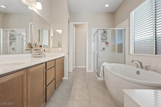 bathroom featuring plus walk in shower, tile patterned flooring, and vanity