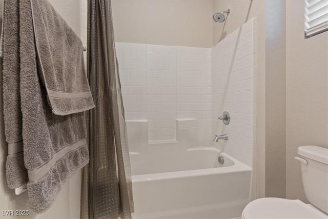 bathroom featuring toilet and shower / bath combo with shower curtain