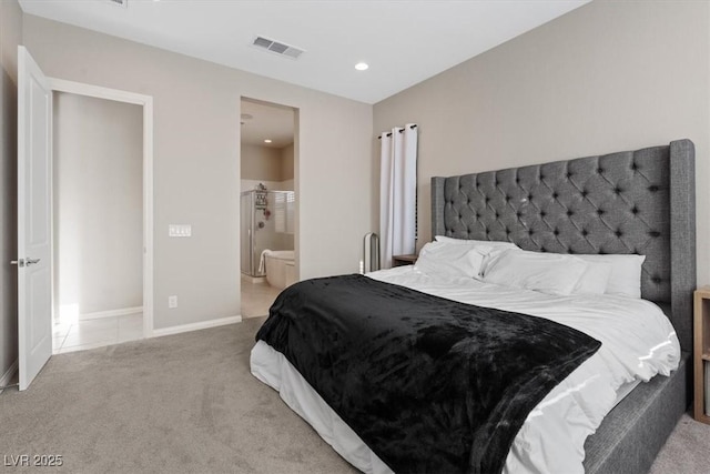 carpeted bedroom featuring ensuite bath