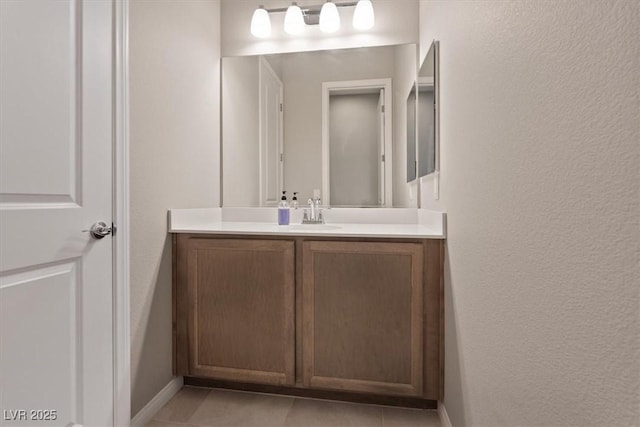 bathroom featuring tile patterned flooring and vanity