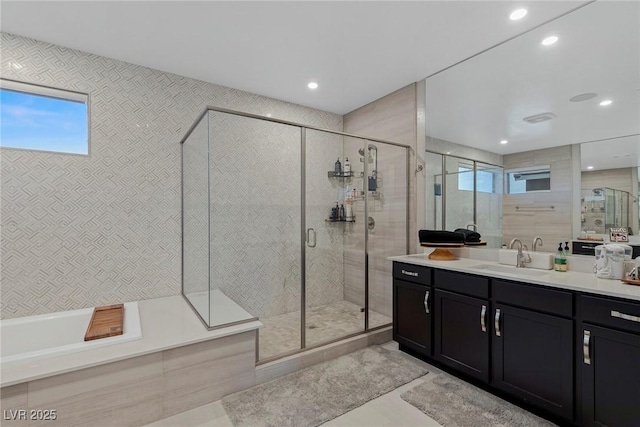 bathroom featuring vanity, independent shower and bath, and tile patterned floors