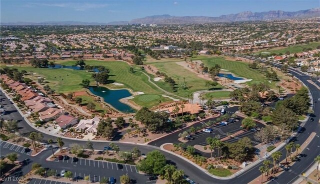 drone / aerial view featuring view of golf course and a water view